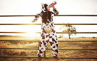 person in black and white cow costume during sunrise