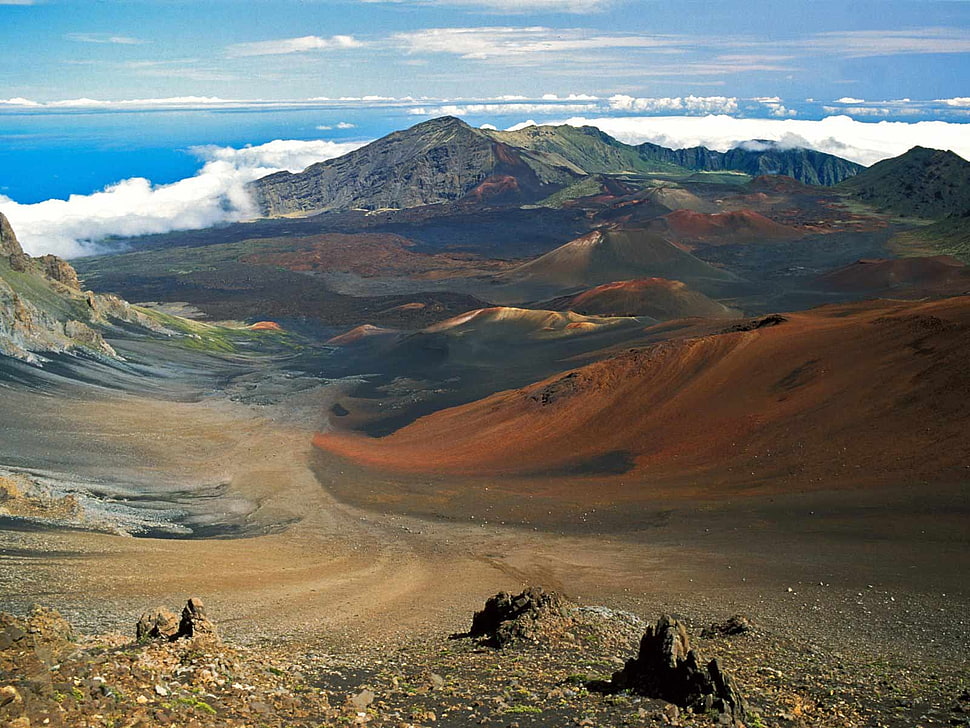 brown and green mountain surrounded by white skies HD wallpaper