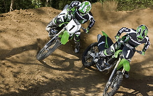 two riders on motocross dirt bikes racing