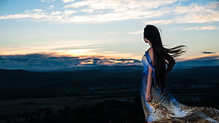woman in blue and brown sleeveless dress posing for photo during sunset